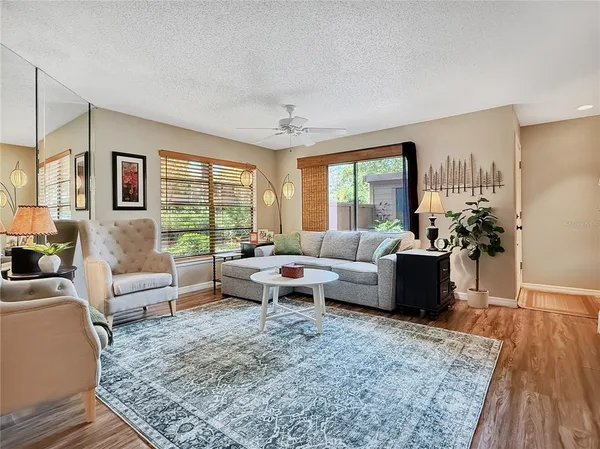 a living room with furniture or couch and a large window