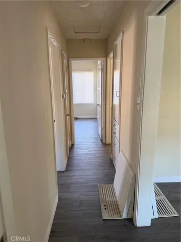 a view of hallway with wooden floor