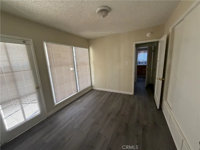a view of a room with wooden floor and window
