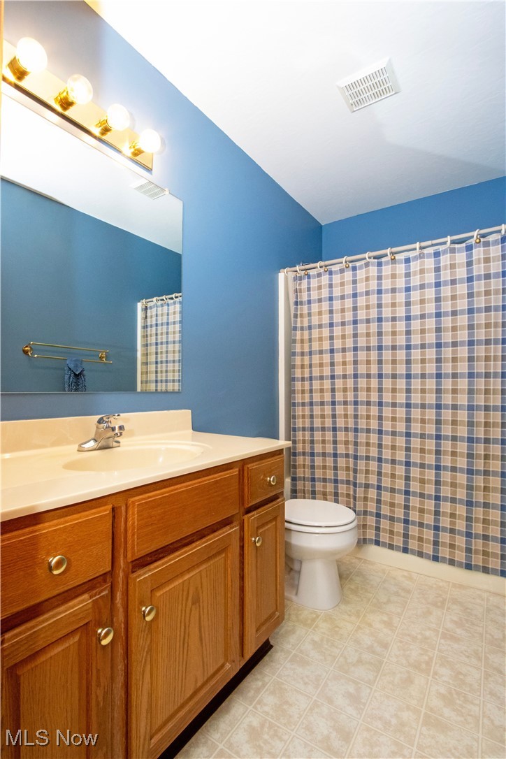 1500 Bell Road Wooster, OH 44691 - Photo 26 of 33 Full bathroom with toilet, vanity, and a shower with shower curtain