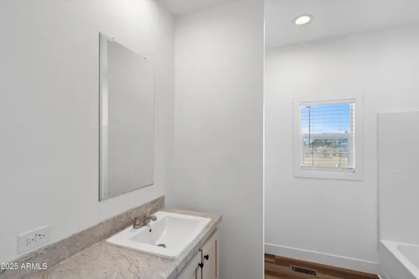 a bathroom with a sink a mirror and a toilet