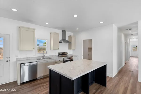 a kitchen with appliances cabinets a sink and a counter top space