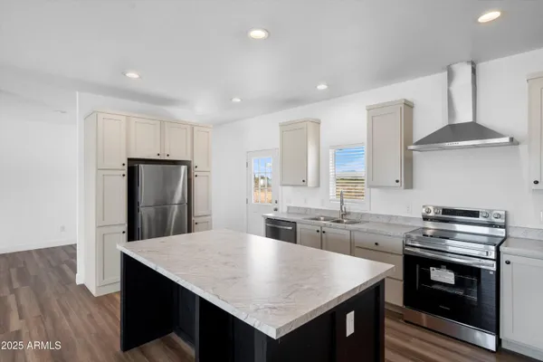 a kitchen with a stove a sink and a refrigerator