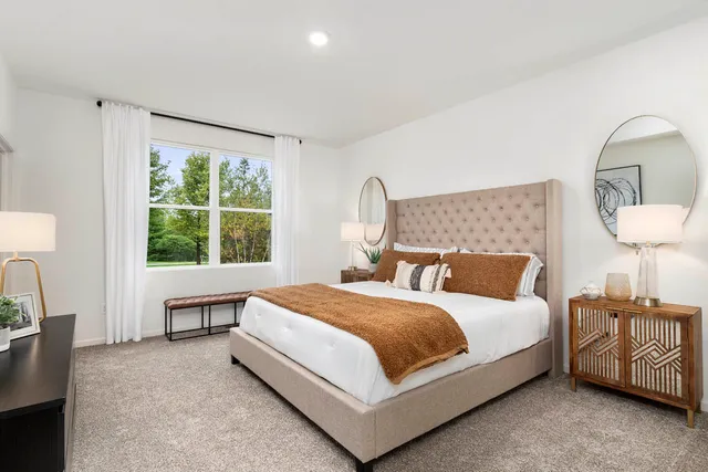 a bedroom with a bed and a painting on the wall