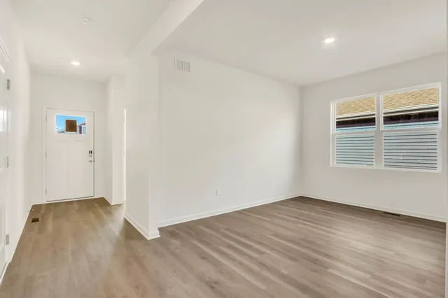 wooden floor in an empty room with a window