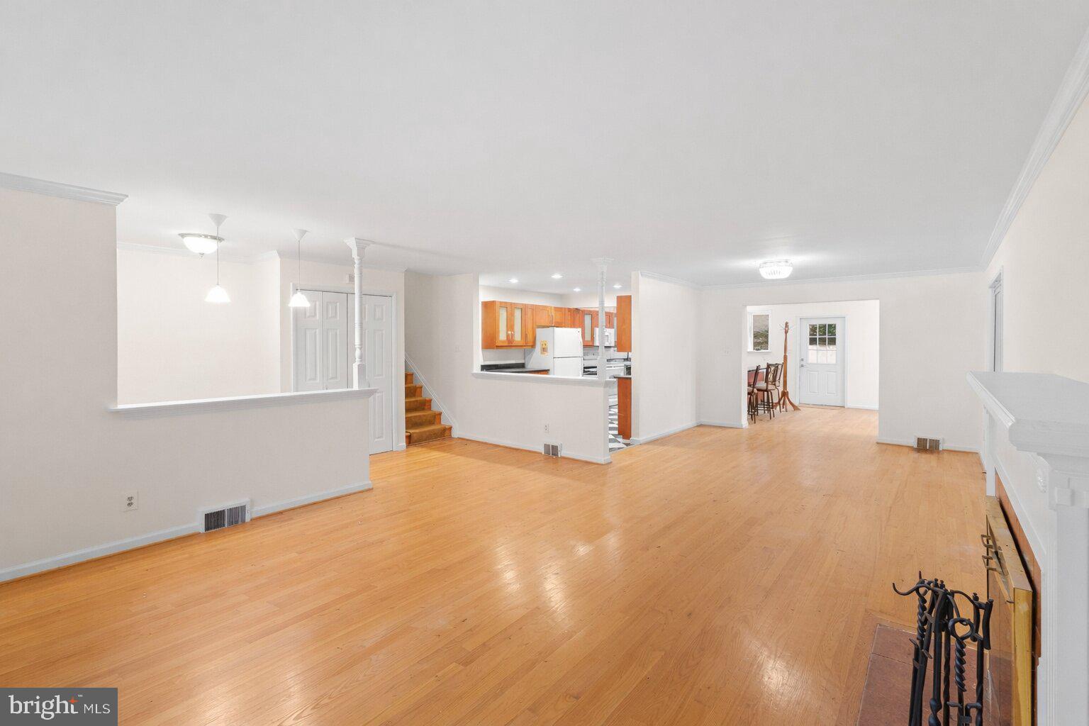 7423 Exmore Street Springfield, VA 22150 - Photo 11 of 39 a view of an empty room with wooden floor and a window