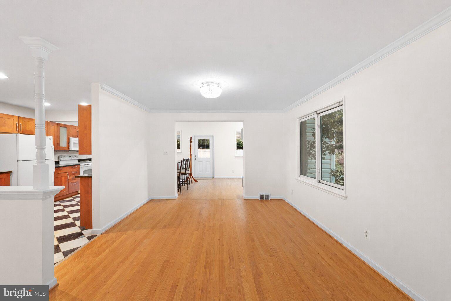 7423 Exmore Street Springfield, VA 22150 - Photo 12 of 39 a big room with wooden floor and windows