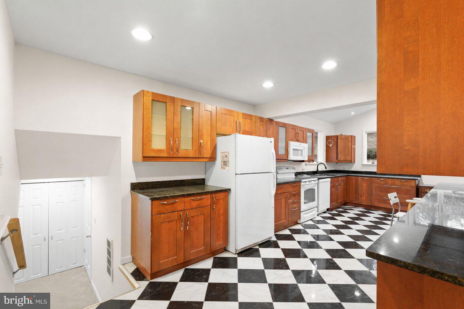 7423 Exmore Street Springfield, VA 22150 - Photo 13 of 39 a kitchen with stainless steel appliances granite countertop a refrigerator and a stove top oven