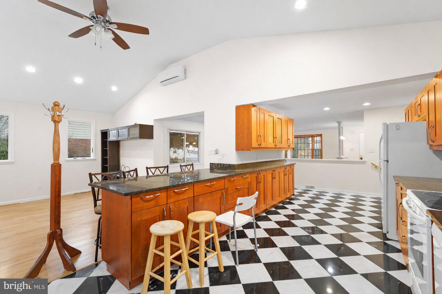 7423 Exmore Street Springfield, VA 22150 - Photo 15 of 39 a large kitchen with stainless steel appliances a sink and a refrigerator