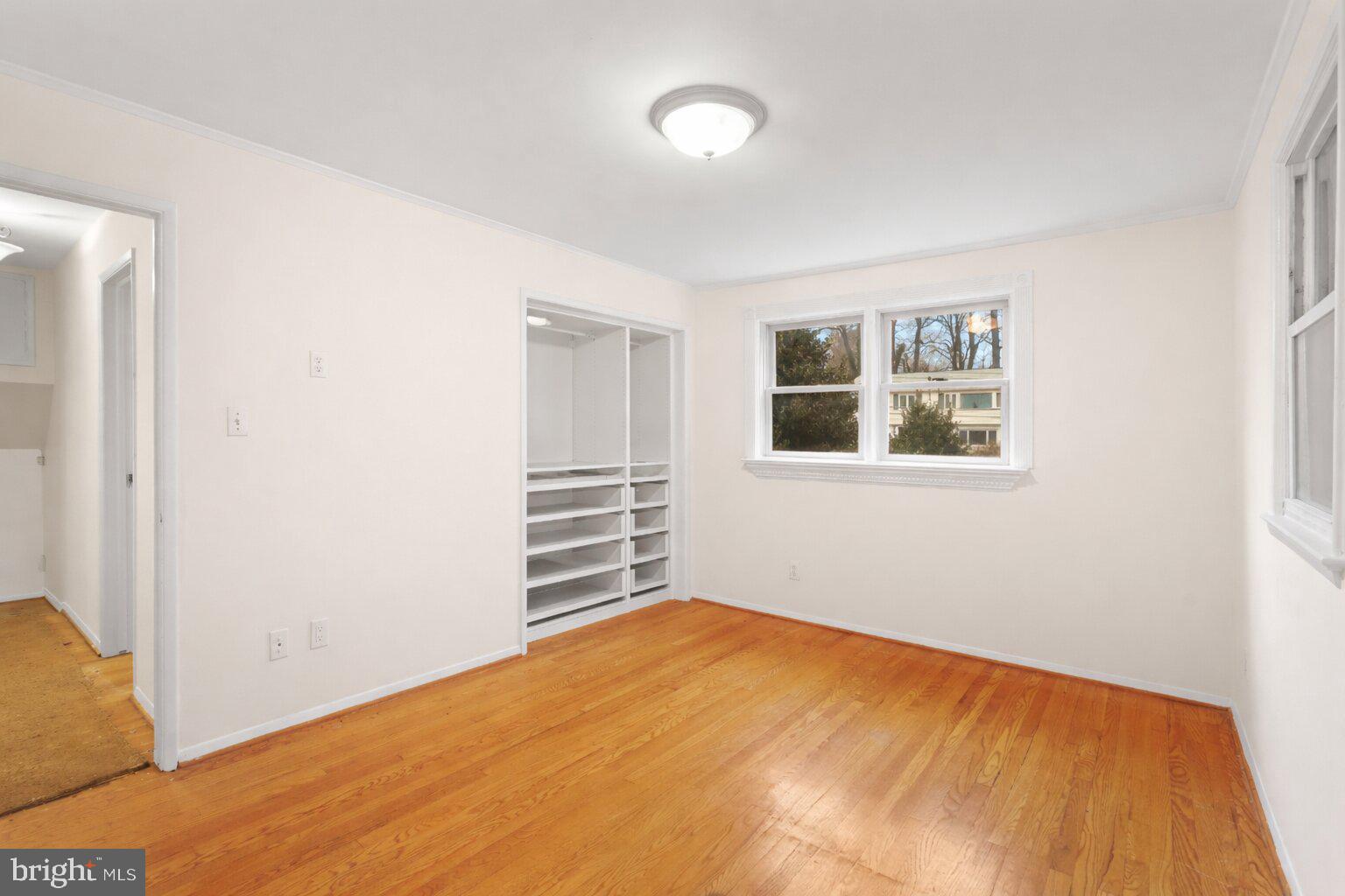 7423 Exmore Street Springfield, VA 22150 - Photo 17 of 39 a view of empty room with wooden floor and fan