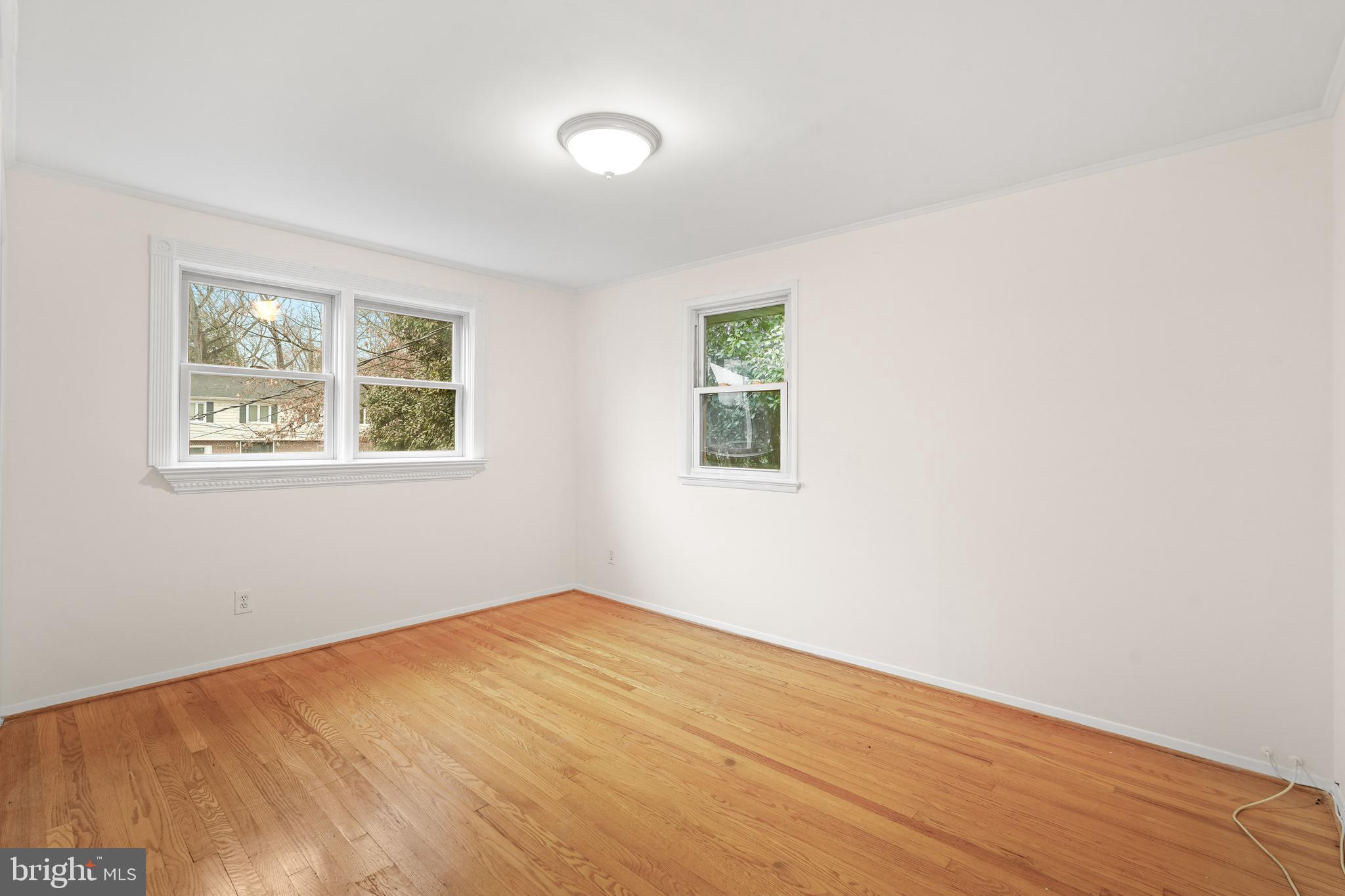 7423 Exmore Street Springfield, VA 22150 - Photo 19 of 39 a view of an empty room with wooden floor and a window