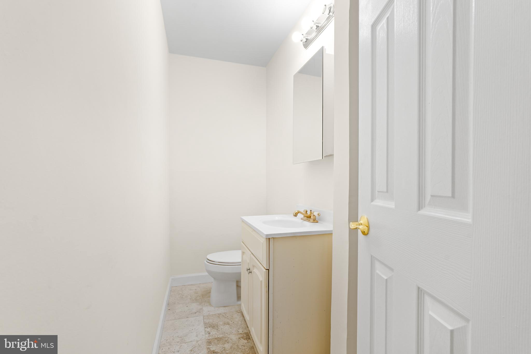 7423 Exmore Street Springfield, VA 22150 - Photo 27 of 39 a bathroom with a toilet and a sink