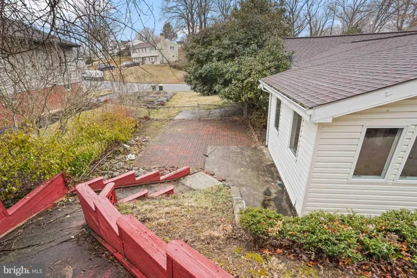 a view of a house with a yard and wooden fence