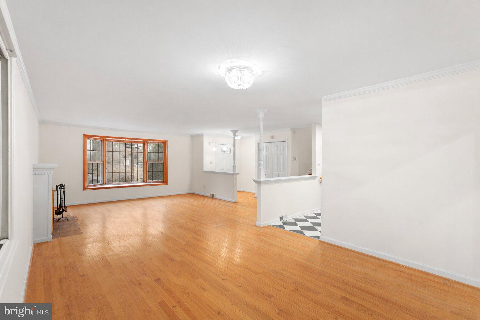 7423 Exmore Street Springfield, VA 22150 - Photo 9 of 39 a view of an empty room with a window and wooden floor
