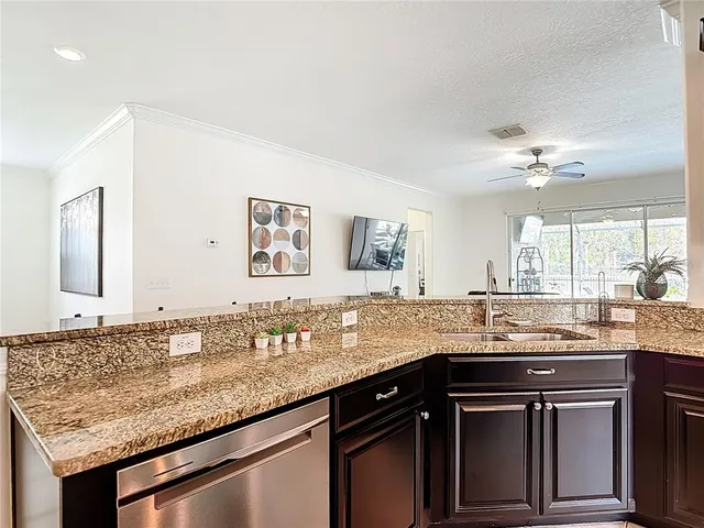 a kitchen with granite countertop kitchen island cabinets and refrigerator