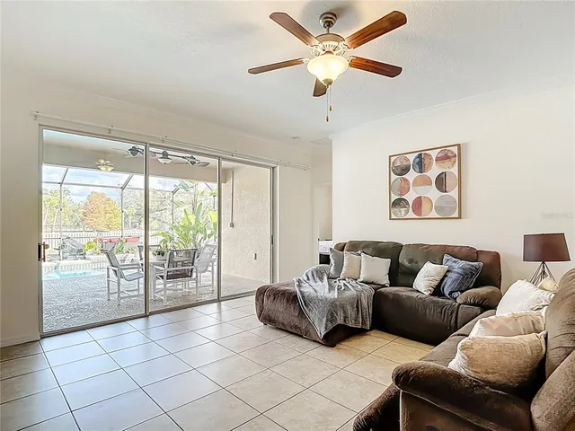 a bedroom with a bed ceiling fan and a window