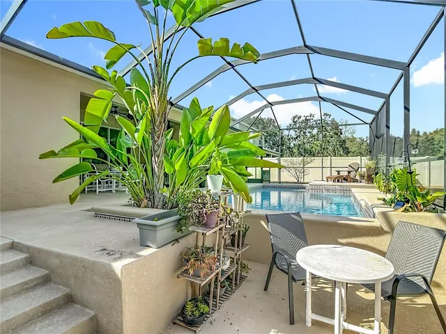 an aerial view of residential house with outdoor space and swimming pool