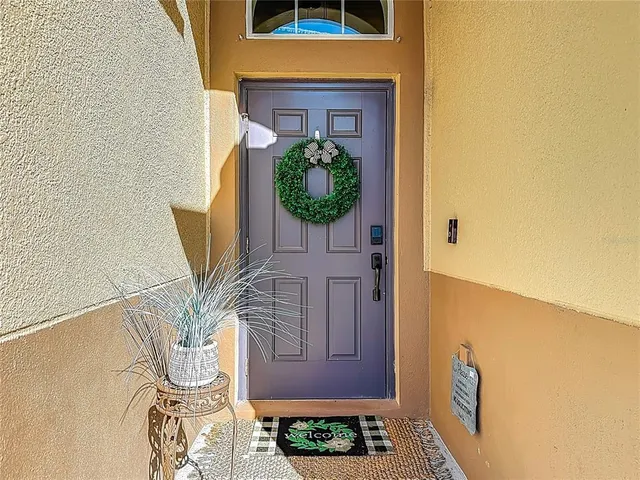 a view of a hallway with furniture and a window