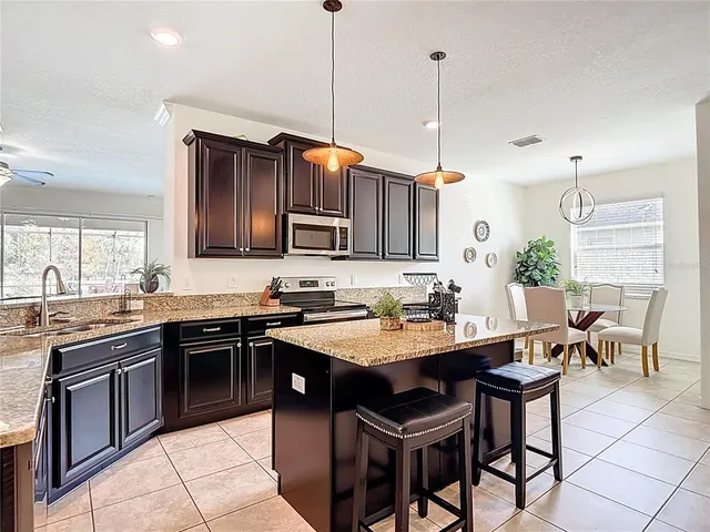 a kitchen with granite countertop a sink and cabinets
