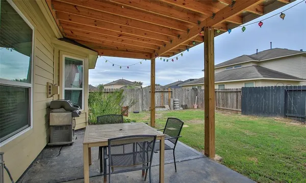 a view of a porch with furniture and a yard