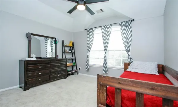 a living room with a bed and a window