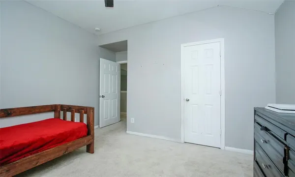 a bedroom with a bed and a mirror