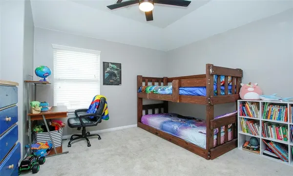 a reading room with furniture and a book shelf