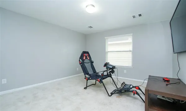 a view of a room with gym equipment and a window