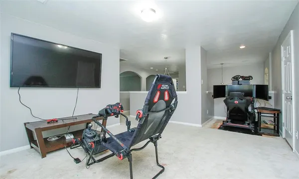 a view of a livingroom with furniture and a flat screen tv
