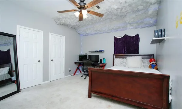 a bedroom with a bed and a tv
