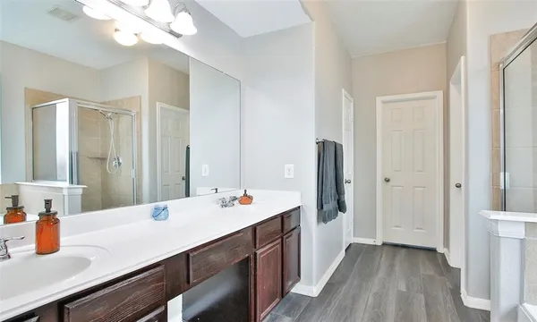 a bathroom with a sink a vanity and a mirror