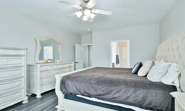 a bedroom with a large bed and a chandelier
