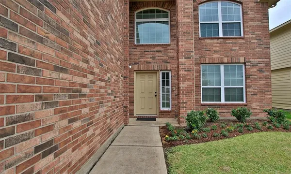 a view of a brick house with a yard