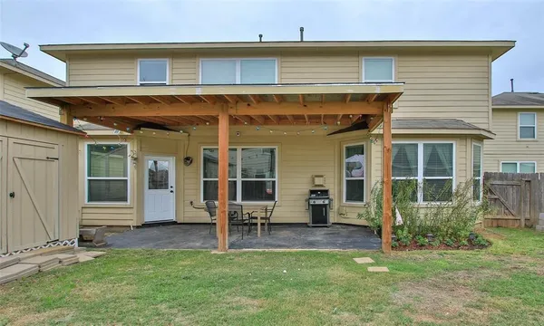 a view of a house with a yard and sitting area