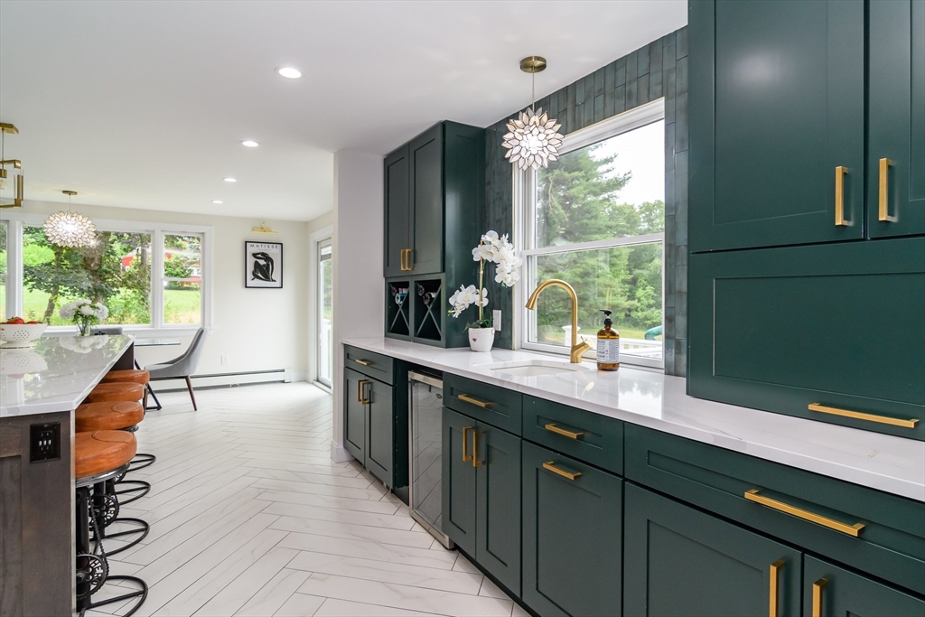 124 Everett Street Natick, MA 01760 - Photo 11 of 36 a kitchen with stainless steel appliances granite countertop sink stove and cabinets