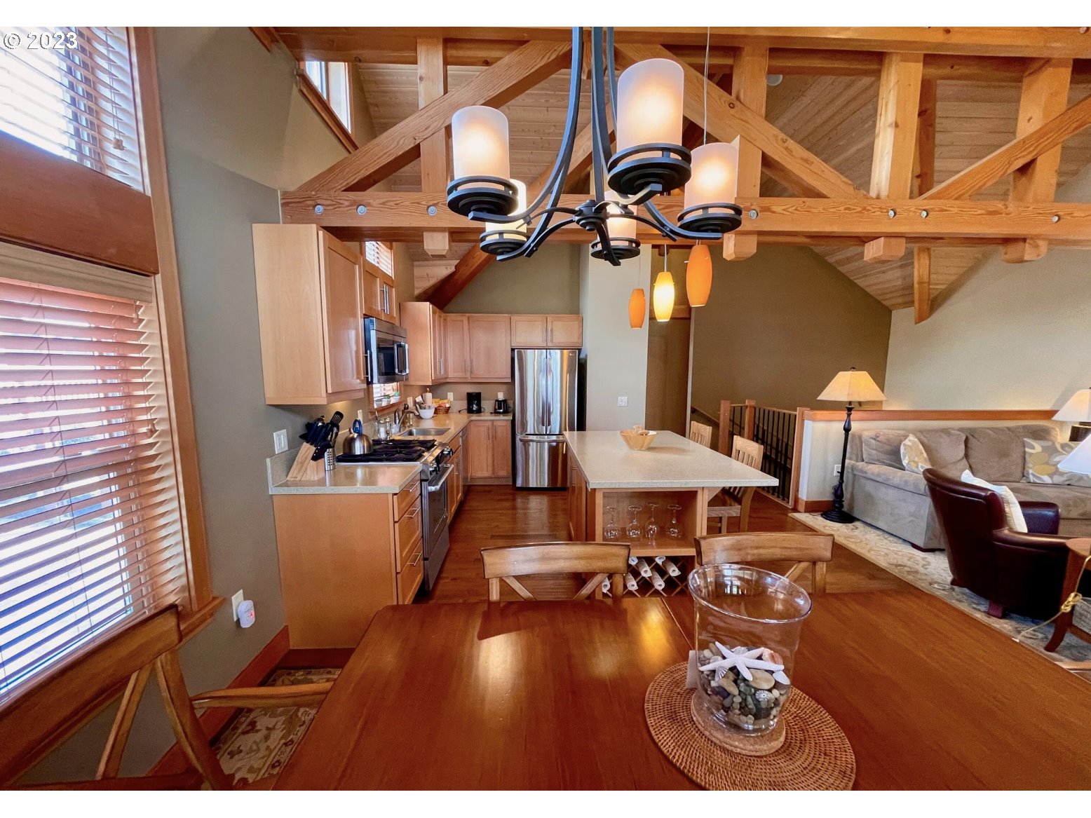 Lodges At Cannon Bea, Unit B2 Cannon Beach, OR 97110 - Photo 14 of 25 a view of a dining room with furniture a chandelier and wooden floor