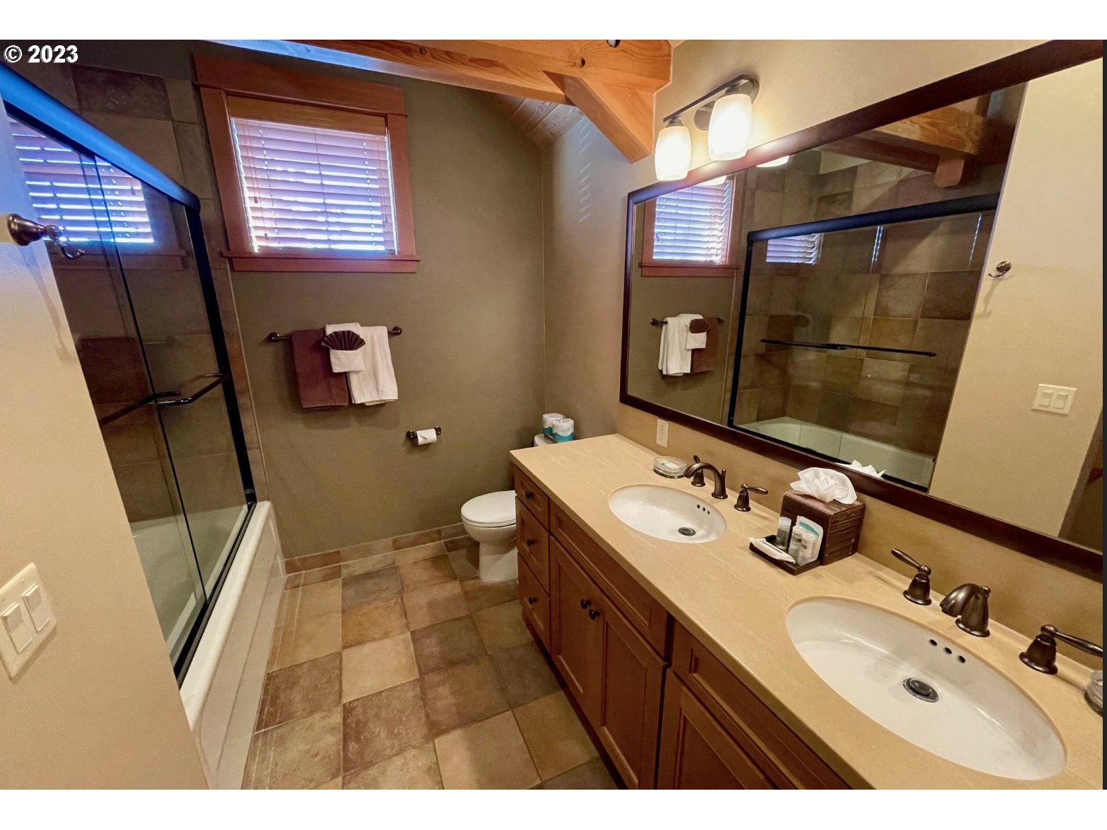 Lodges At Cannon Bea, Unit B2 Cannon Beach, OR 97110 - Photo 18 of 25 a bathroom with a sink mirror and toilet