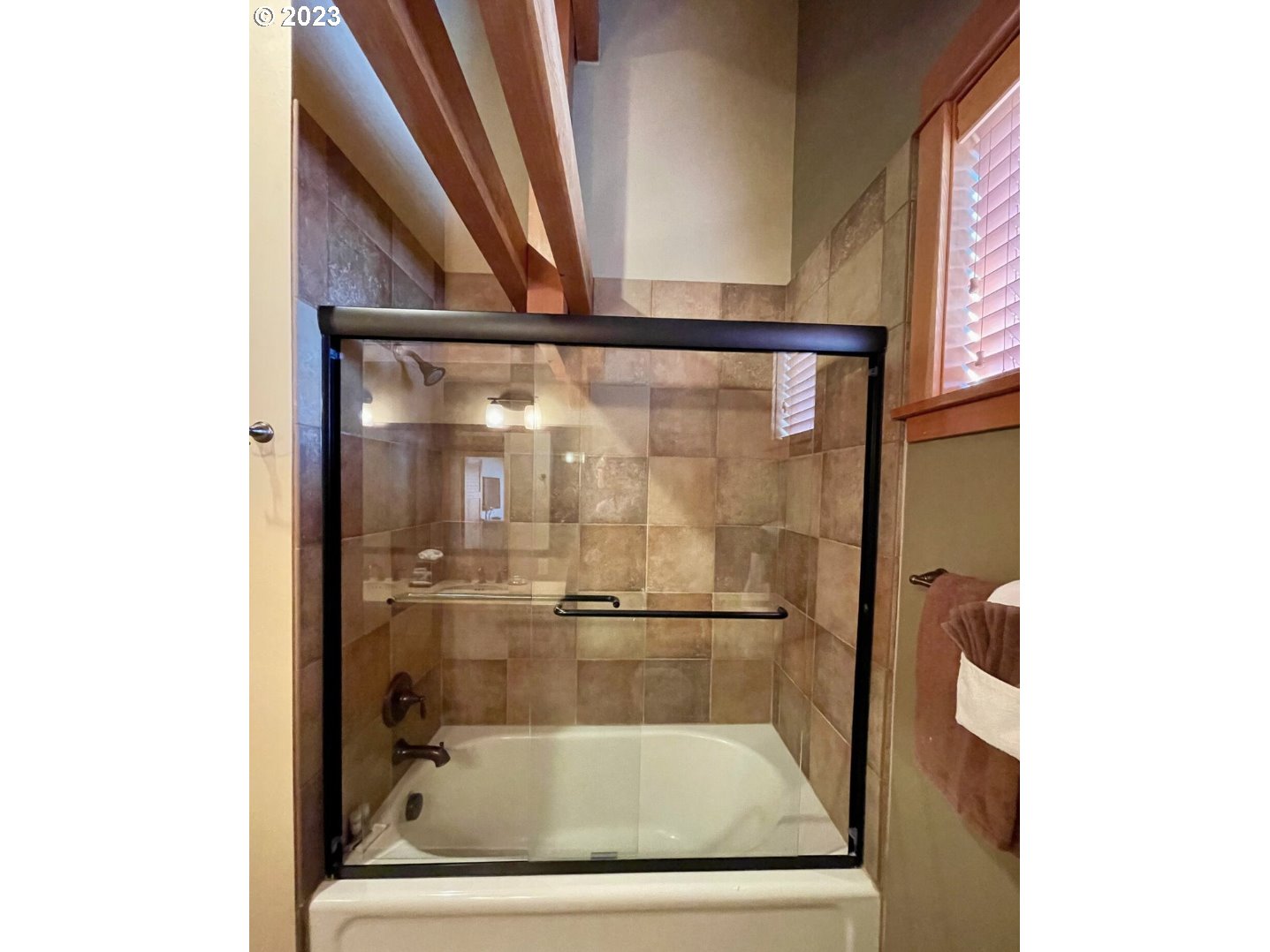 Lodges At Cannon Bea, Unit B2 Cannon Beach, OR 97110 - Photo 19 of 25 a bathroom with a glass shower door
