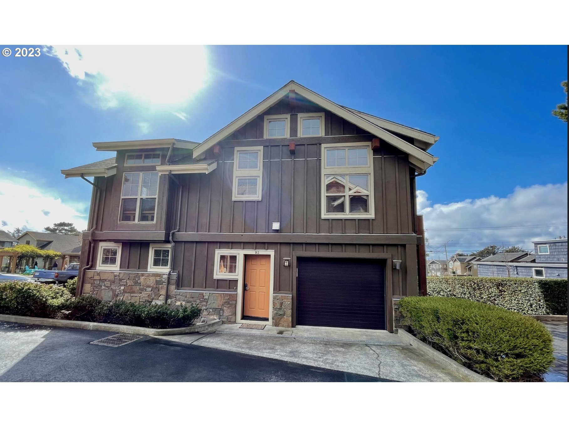 Lodges At Cannon Bea, Unit B2 Cannon Beach, OR 97110 - Photo 2 of 25 a front view of a house with yard