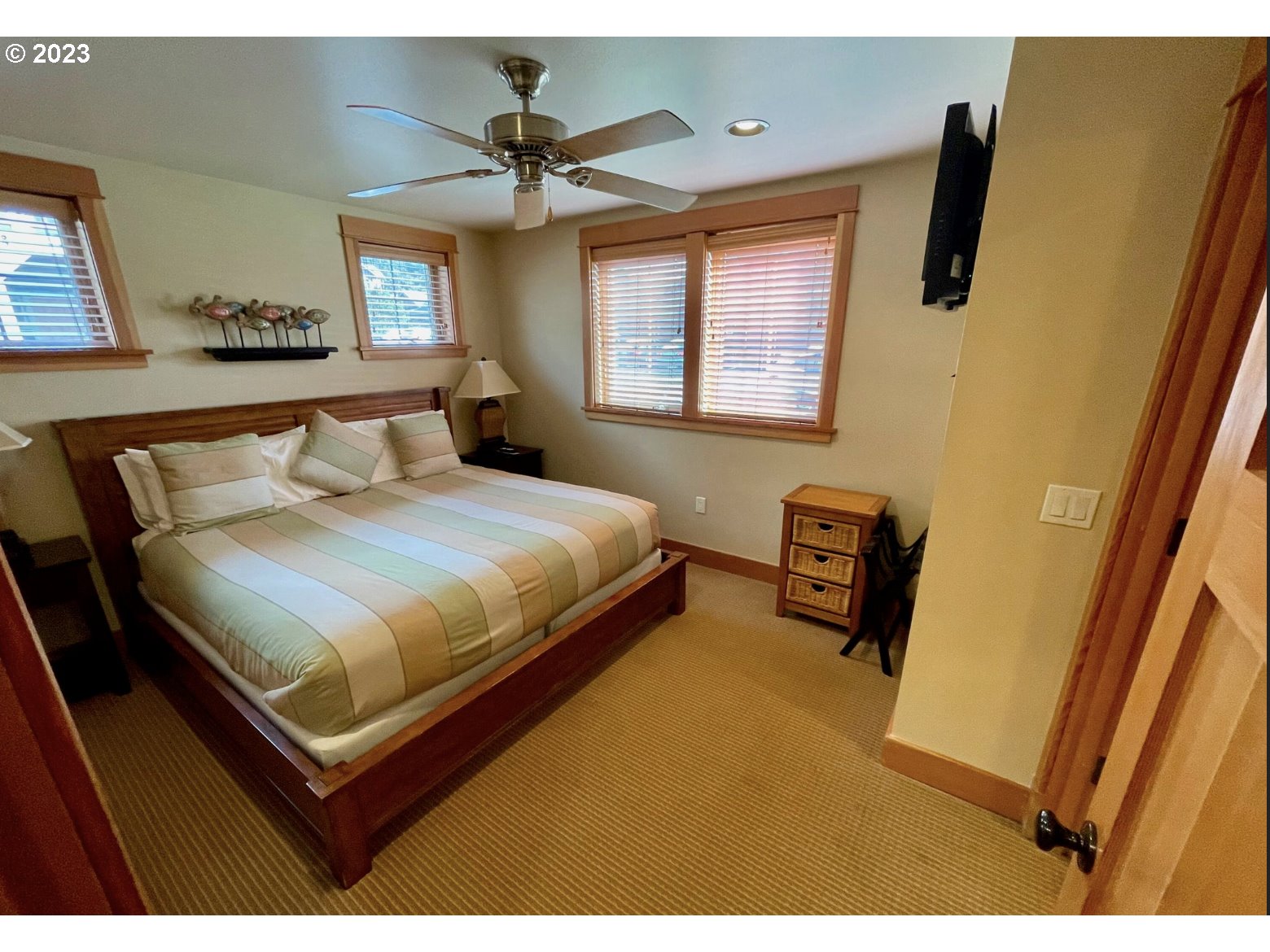 Lodges At Cannon Bea, Unit B2 Cannon Beach, OR 97110 - Photo 3 of 25 a bedroom with a bed and wooden floor