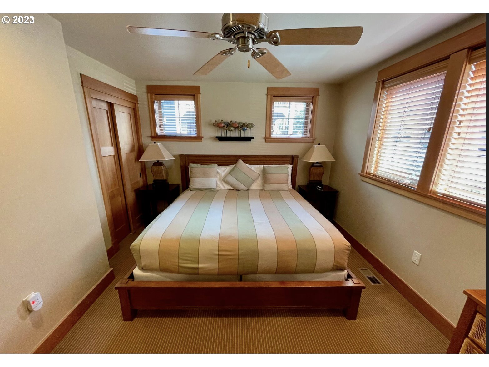 Lodges At Cannon Bea, Unit B2 Cannon Beach, OR 97110 - Photo 4 of 25 a bedroom with a bed and window