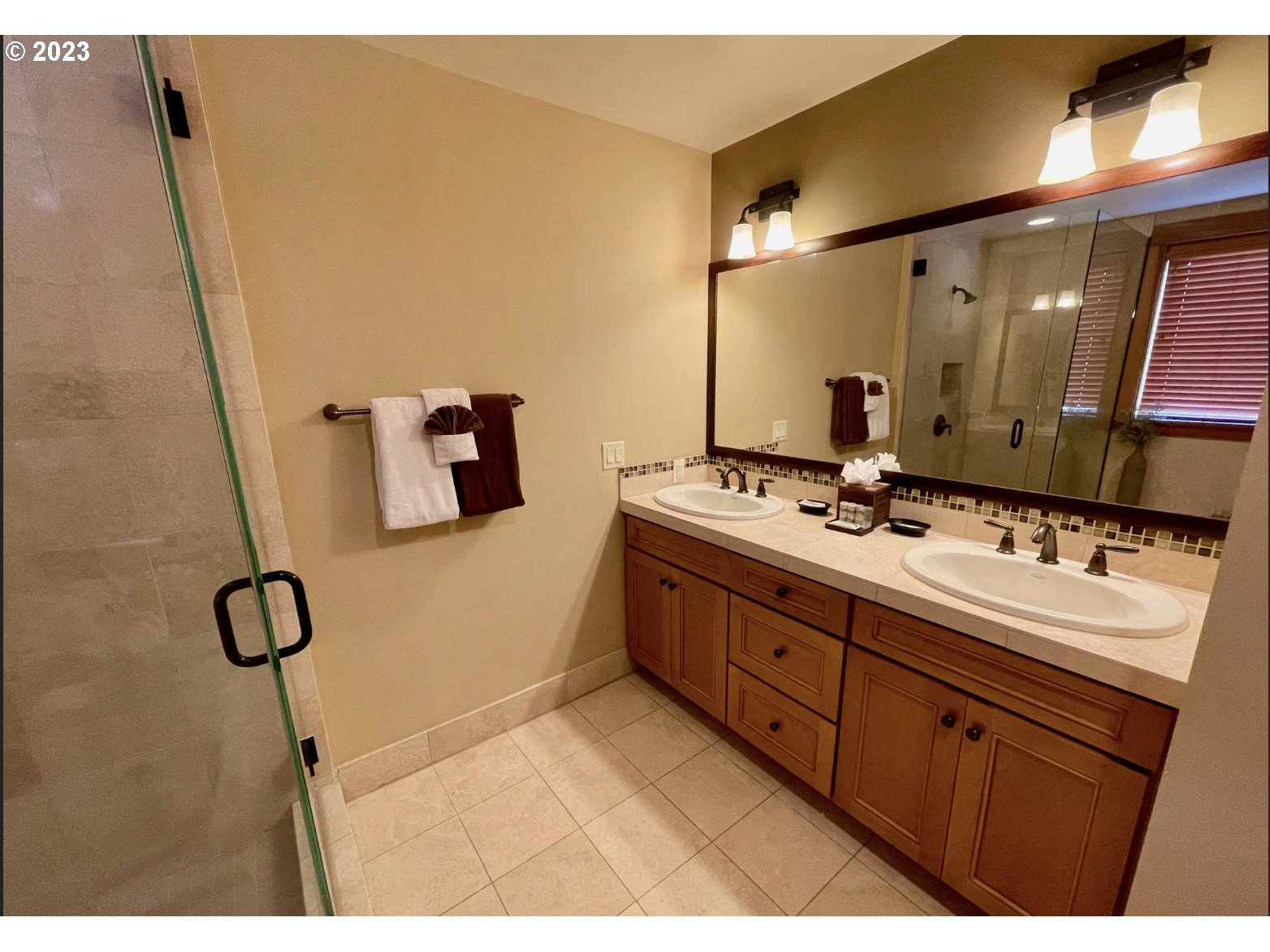 Lodges At Cannon Bea, Unit B2 Cannon Beach, OR 97110 - Photo 7 of 25 a bathroom with a double vanity sink and mirror