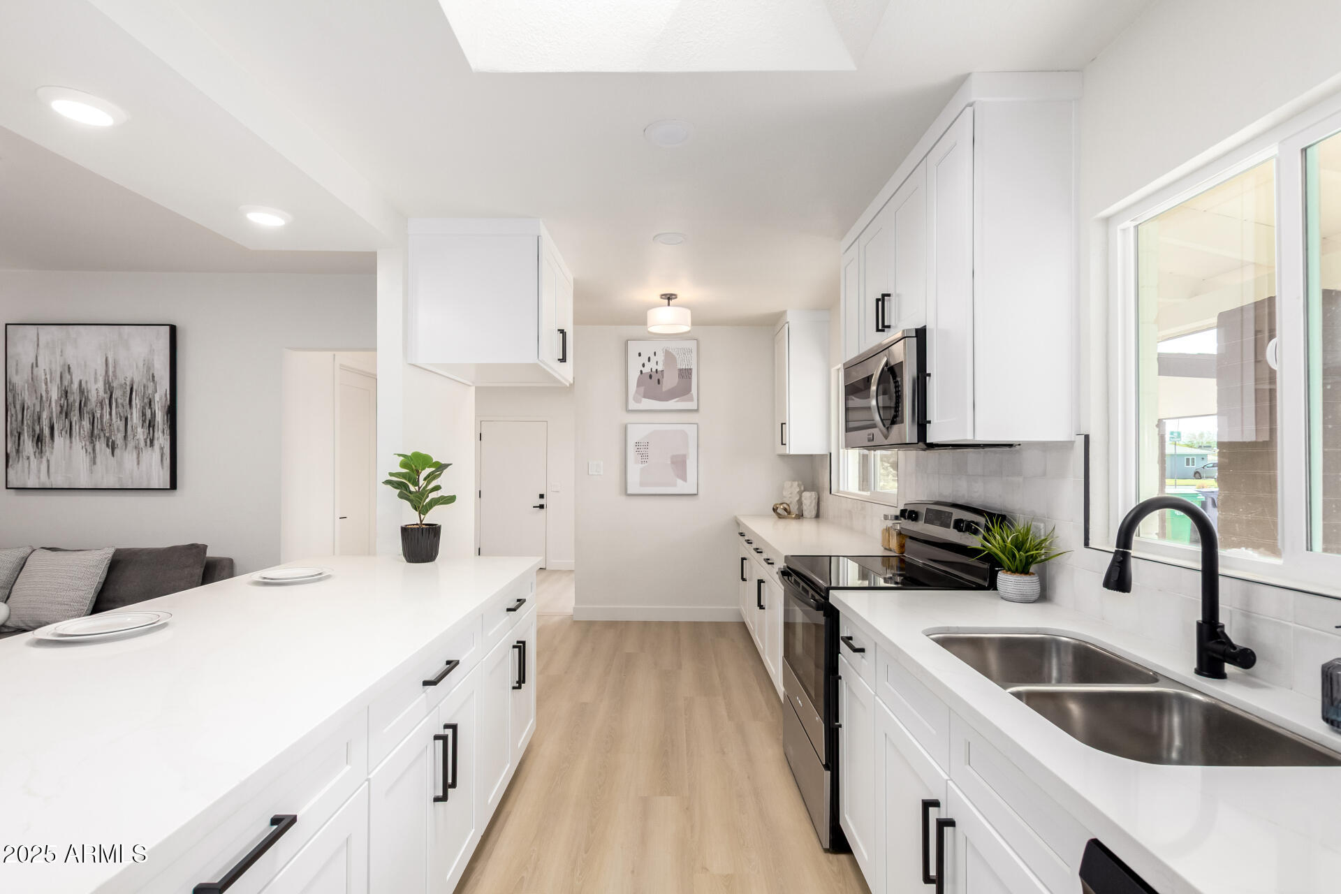 443 North Sycamore Mesa, AZ 85201 - Photo 11 of 42 a kitchen with white cabinets sink and stainless steel appliances