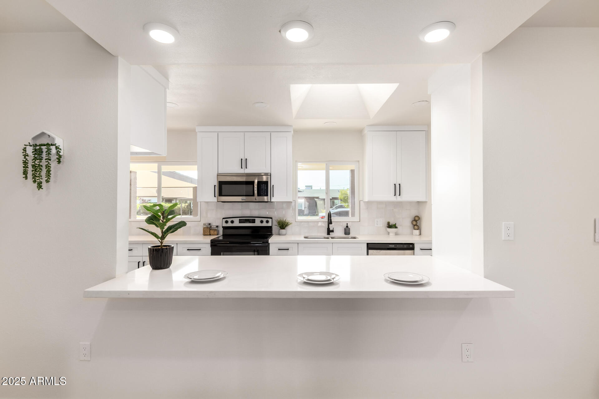 443 North Sycamore Mesa, AZ 85201 - Photo 13 of 42 a kitchen with stainless steel appliances a sink a microwave a refrigerator a counter top space and cabinets