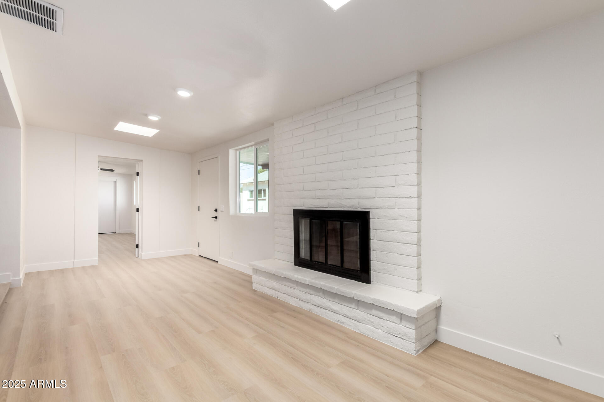 443 North Sycamore Mesa, AZ 85201 - Photo 15 of 42 a view of an empty room with wooden floor and a fireplace