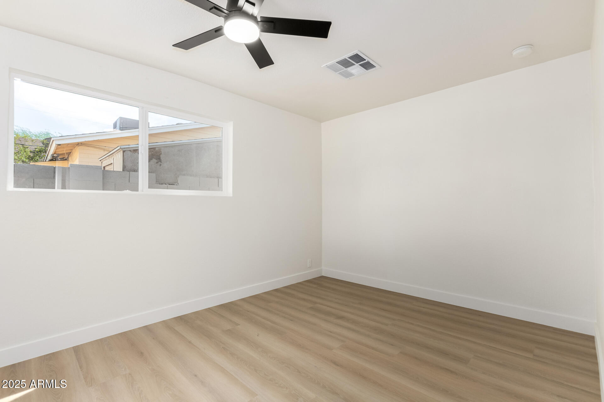 443 North Sycamore Mesa, AZ 85201 - Photo 23 of 42 an empty room with a window and a ceiling fan