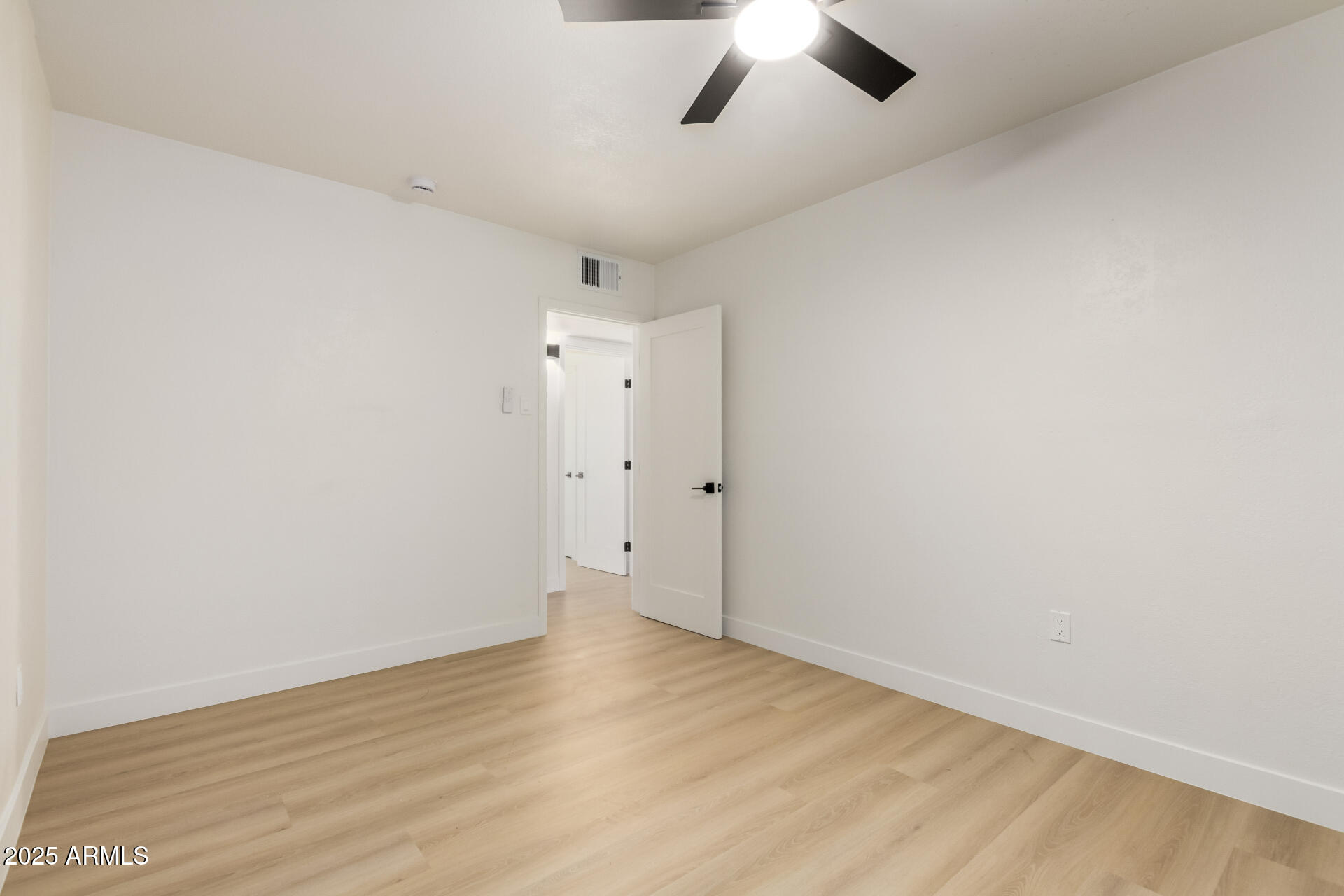 443 North Sycamore Mesa, AZ 85201 - Photo 27 of 42 an empty room with a ceiling fan and wooden floor