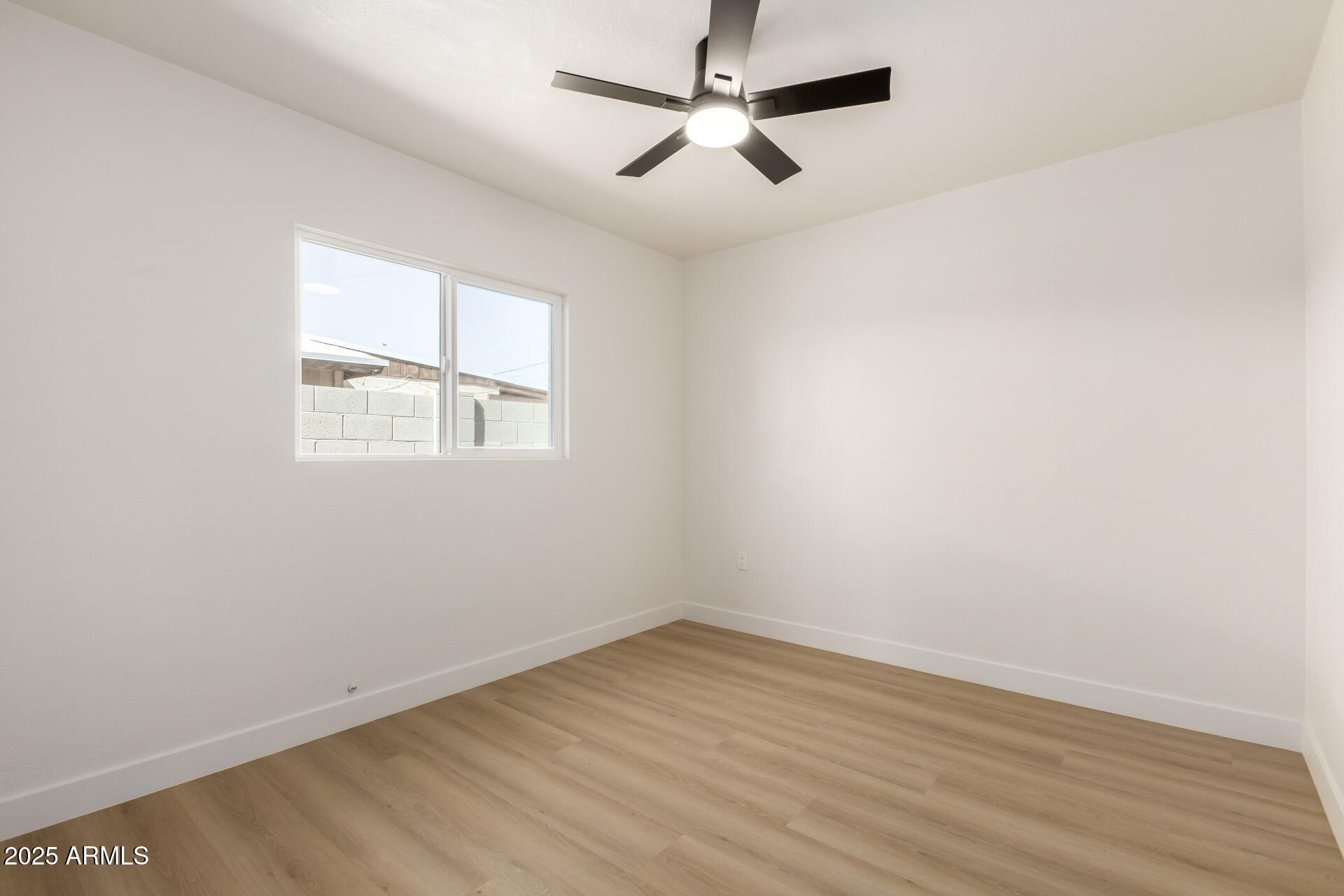 443 North Sycamore Mesa, AZ 85201 - Photo 29 of 42 an empty room with wooden floor ceiling fan and windows