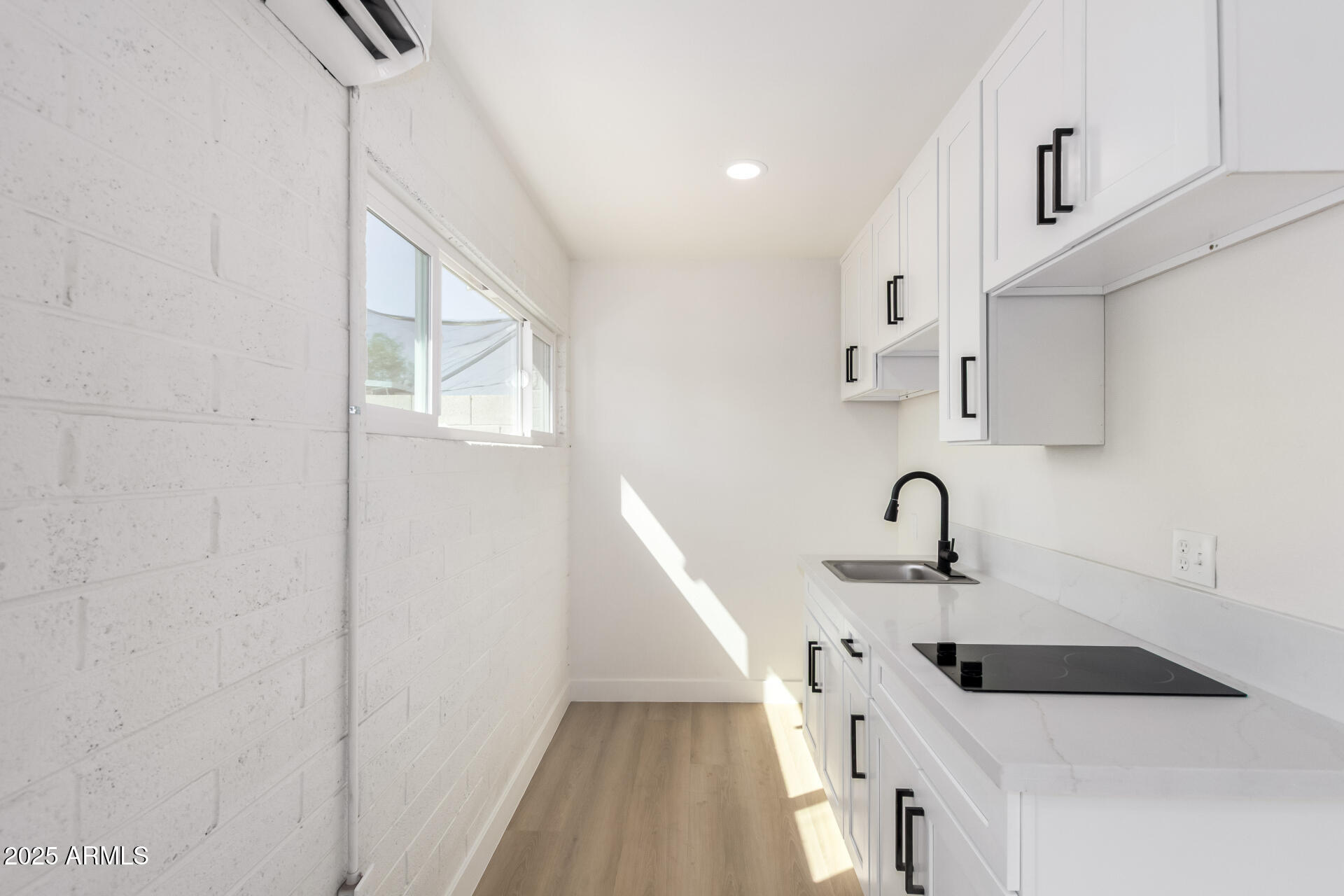 443 North Sycamore Mesa, AZ 85201 - Photo 34 of 42 a kitchen with white cabinets a sink a window and a refrigerator
