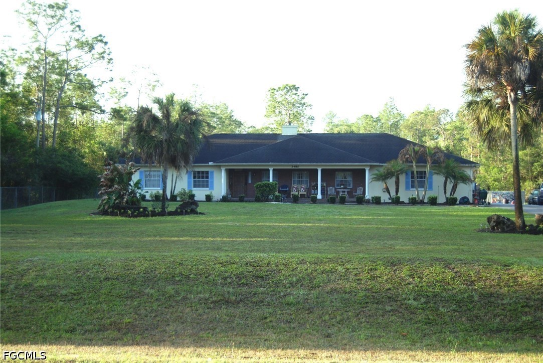 3480 4th Avenue Southeast Naples, FL 34117 - Photo 1 of 15 a front view of a house with a garden